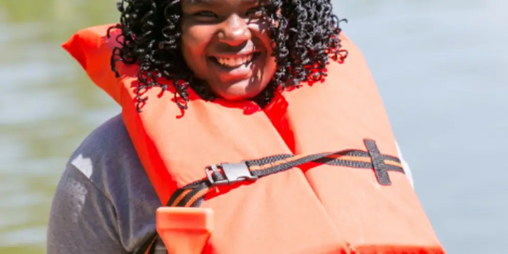teen with intellectual disability getting ready to kayak at an inclusive camp