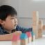 young boy playing building blocks practicing executive functioning skills