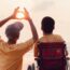 Father and his disabled son traveling for the summer at the beach with his son in his wheelchair